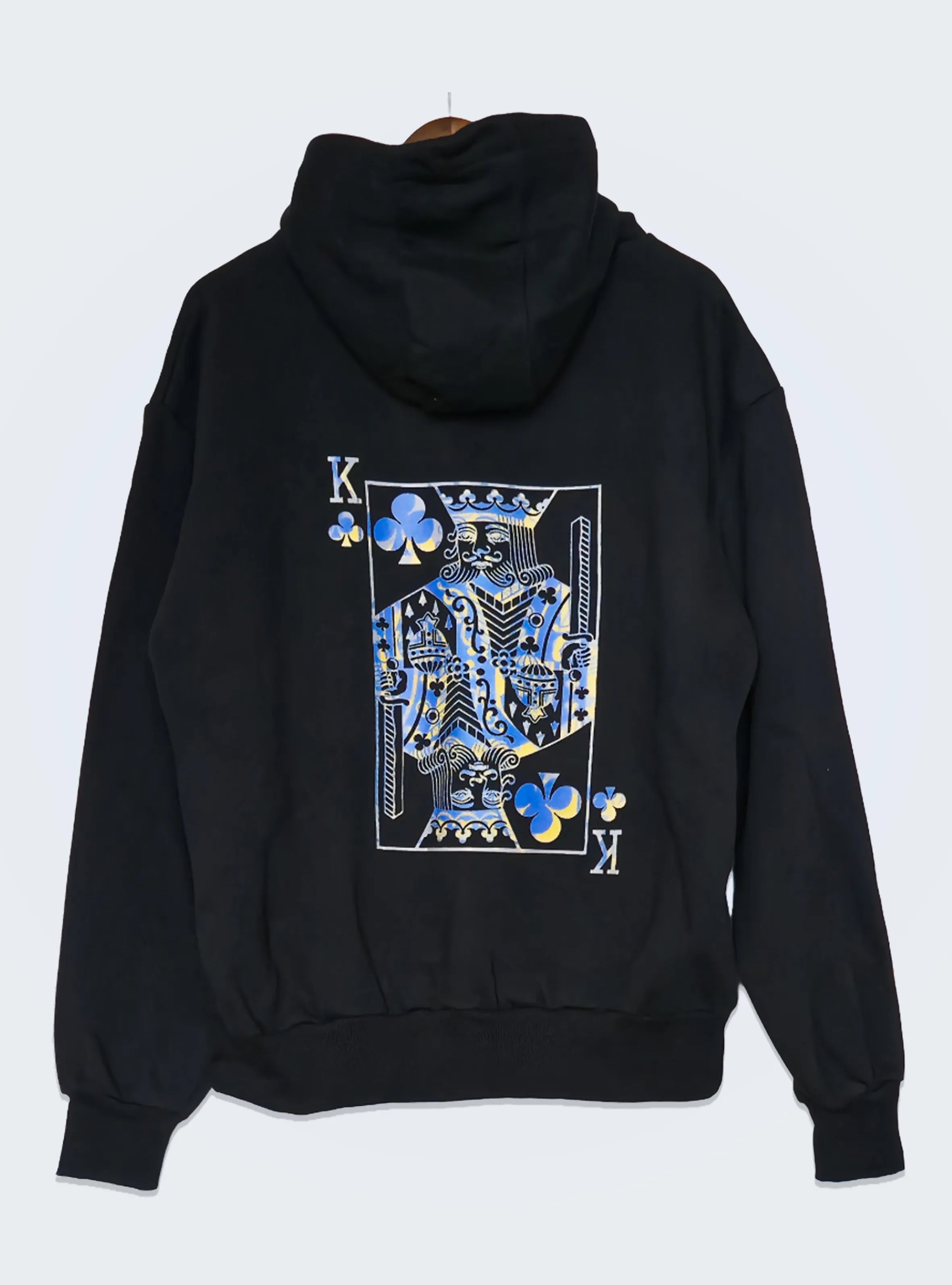 Black hoodie with a king of clubs card design on the back against a white background.