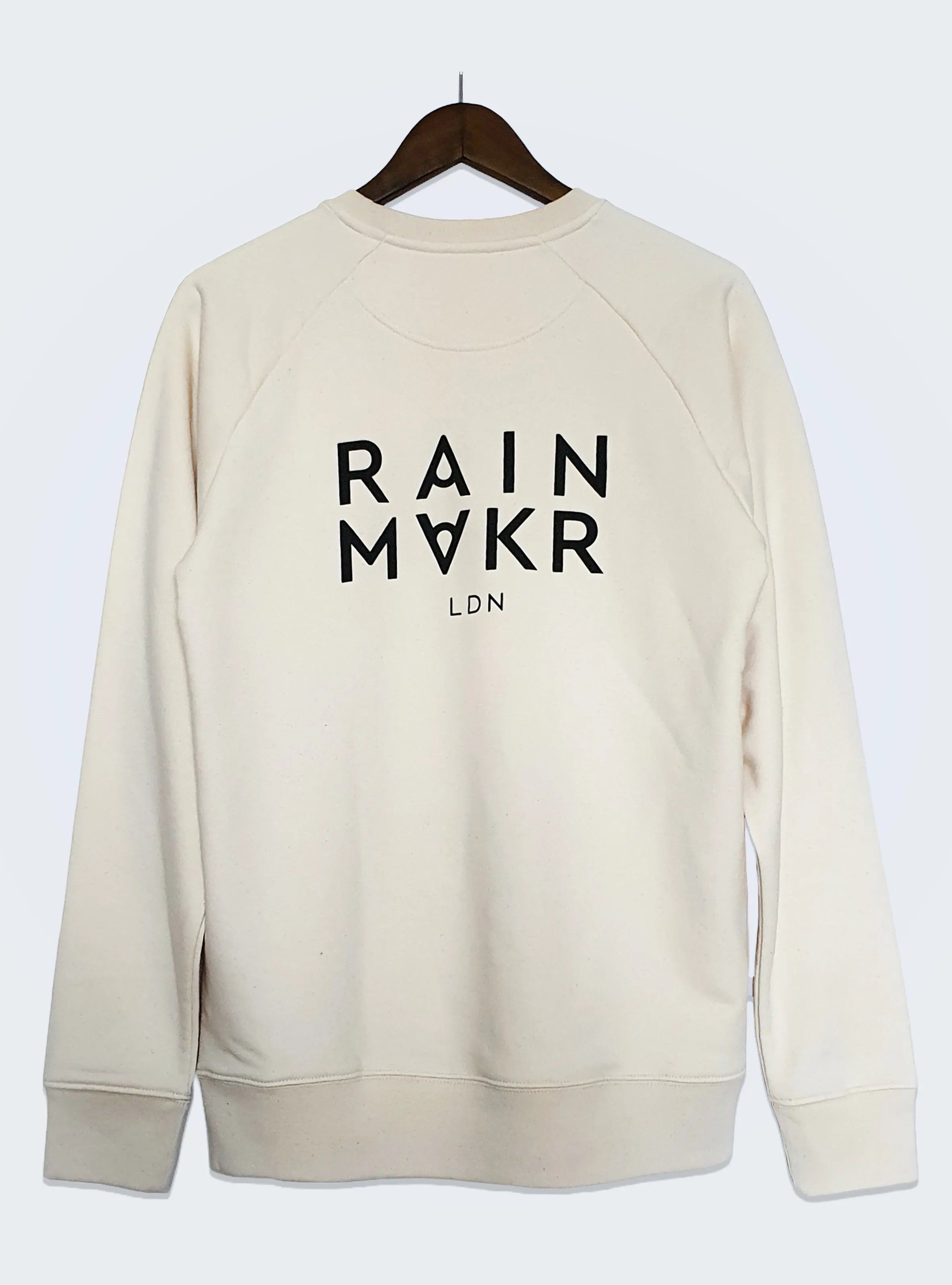 a beige long-sleeve crewneck jumper with 'RAINMAKR' text printed at the middle back.