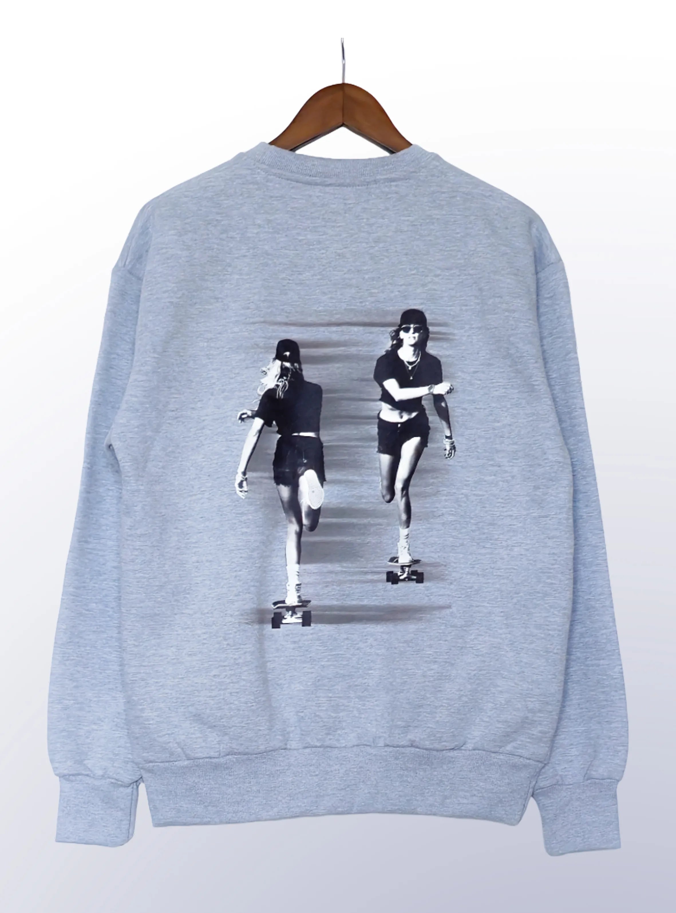 Grey sweatshirt with graphic design of person on skateboard