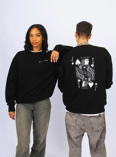 Two people wearing a black jumper with a graphic design of a Jack of Spades from a deck of cards.